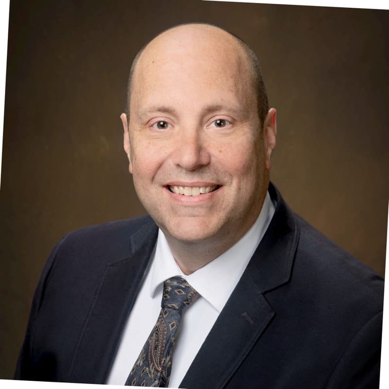 man in suit smiling at camera